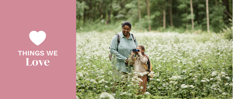 Mother and child with binoculars in nature