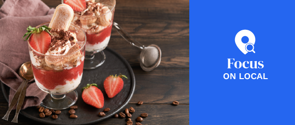 Strawberry tiramisu. Traditional Italian dessert tiramisu in glass with fresh strawberry and mint leaves on old wooden dark table background.