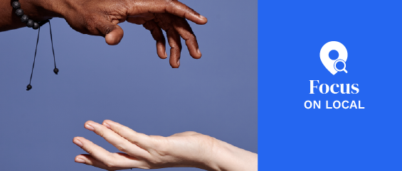 two hands reaching out on a purple background