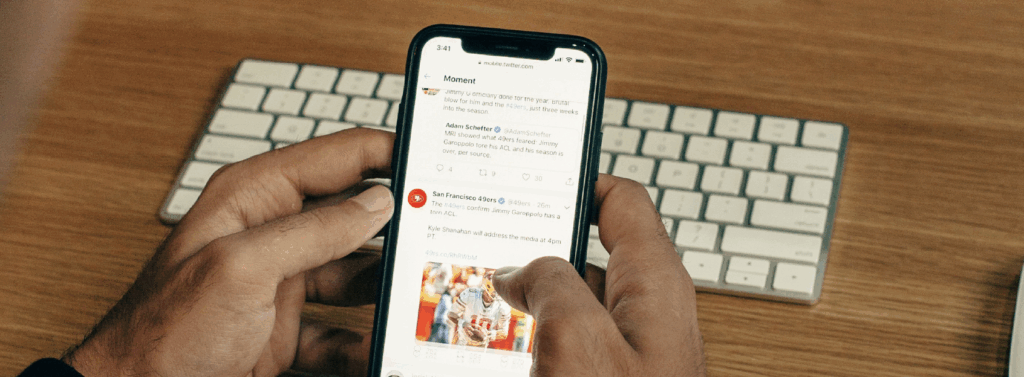 man holding phone while leaning on table man holding phone while leaning on table
