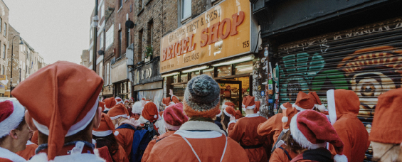 people wearing Santa costume on road