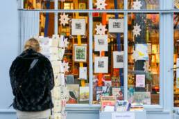 woman picking card at boutique